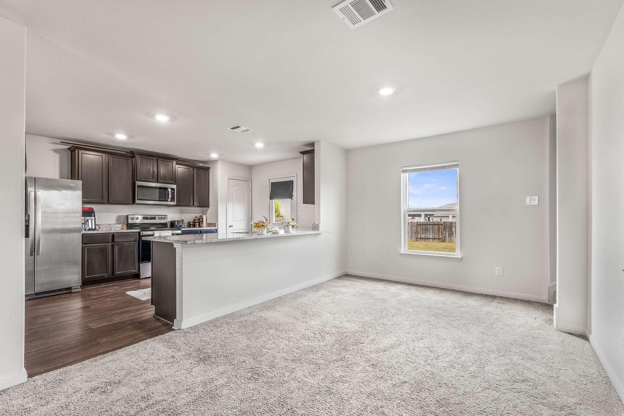 304 Hyacinth Way, Unit #7K Jarrell, TX 76537 - Photo 6 of 26 An inviting open-concept design seamlessly blends living space with a well-appointed kitchen.