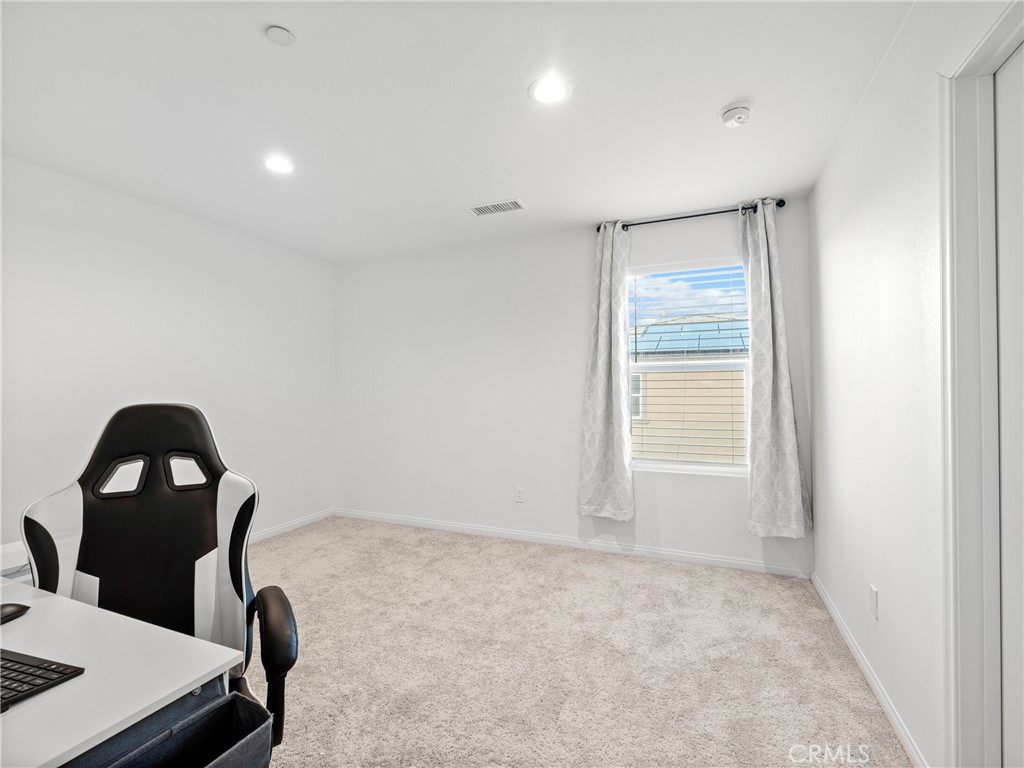 11520 Ferro Street Victorville, CA 92392 - Photo 22 of 40 a room with a chair and a window