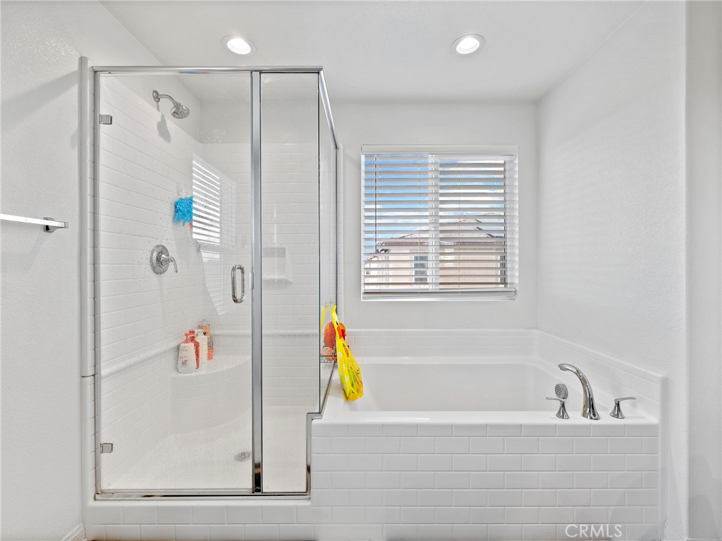 11520 Ferro Street Victorville, CA 92392 - Photo 27 of 40 a bathroom with a bathtub and a shower
