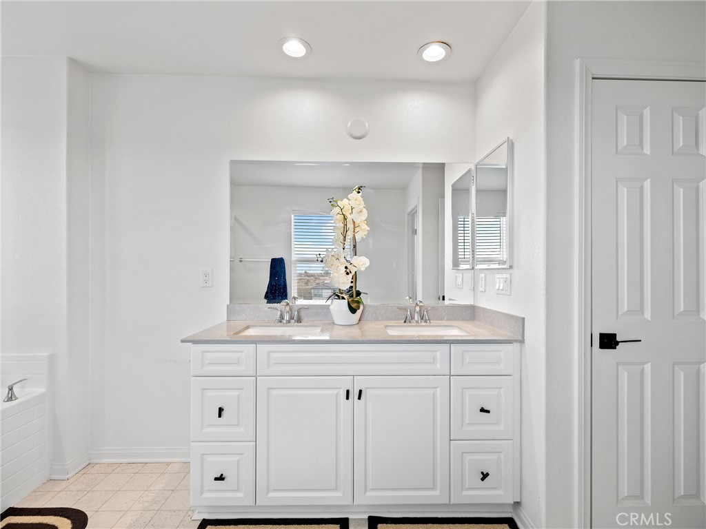 11520 Ferro Street Victorville, CA 92392 - Photo 28 of 40 a bathroom with a sink and a mirror