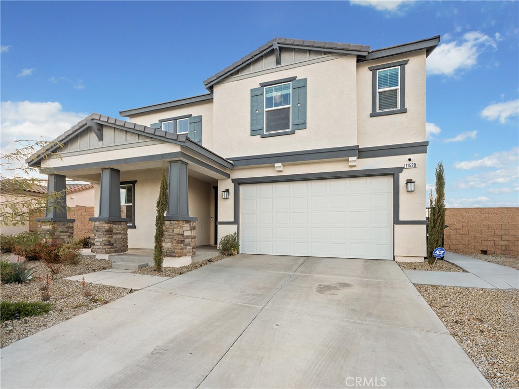 11520 Ferro Street Victorville, CA 92392 - Photo 38 of 40 a front view of a house with a yard and garage