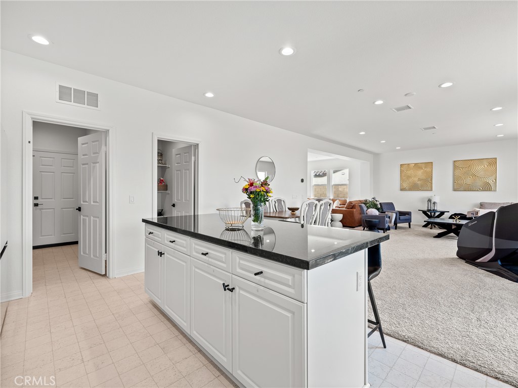 11520 Ferro Street Victorville, CA 92392 - Photo 9 of 40 a view of living room with granite countertop furniture and a chandelier