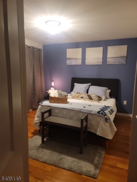 944 Flora Street Elizabeth, NJ 07201 - Photo 12 of 19 a bedroom with a bed a table and painting