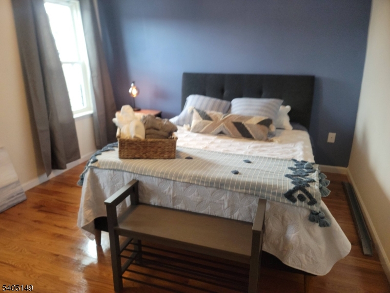 944 Flora Street Elizabeth, NJ 07201 - Photo 14 of 19 a bedroom with a bed and a window