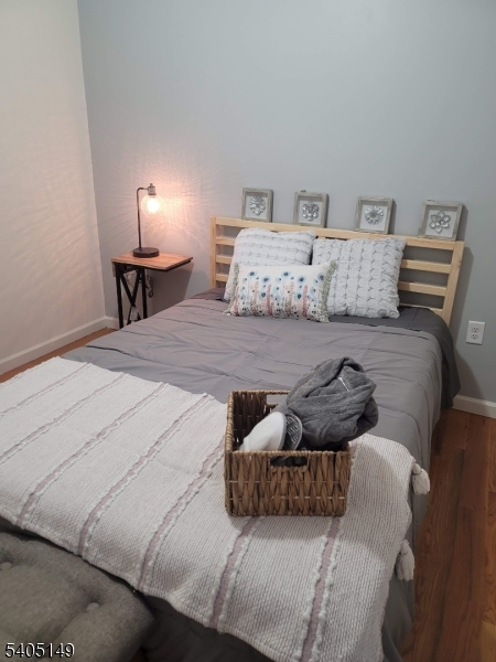 944 Flora Street Elizabeth, NJ 07201 - Photo 15 of 19 a bedroom with a bed and lamp