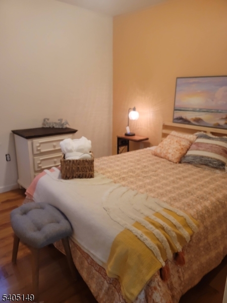 944 Flora Street Elizabeth, NJ 07201 - Photo 16 of 19 a bedroom with a bed and chair