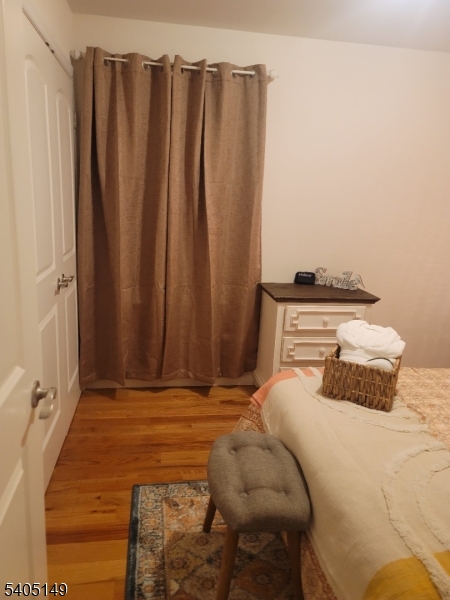 944 Flora Street Elizabeth, NJ 07201 - Photo 17 of 19 a bedroom with a bed and a window