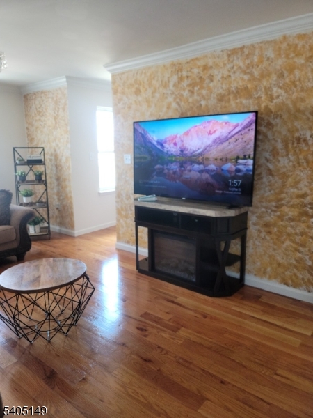 944 Flora Street Elizabeth, NJ 07201 - Photo 3 of 19 a living room with furniture and a fireplace
