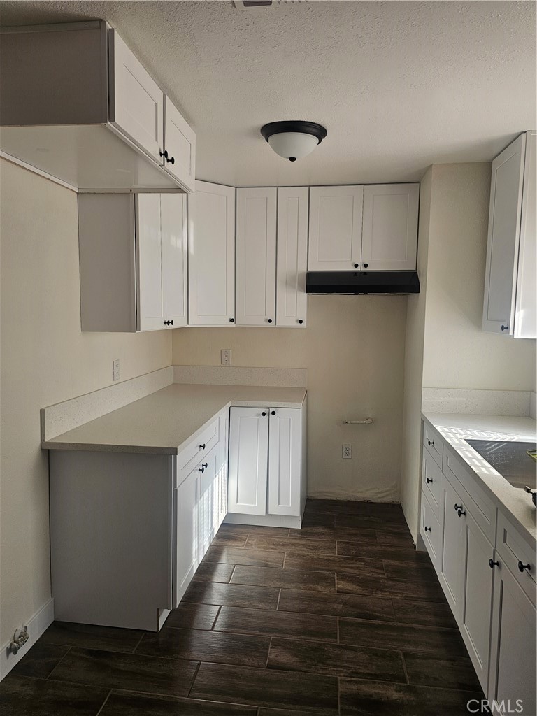 45419 10th Street West, Unit B Lancaster, CA 93534 - Photo 5 of 18 a kitchen with cabinets wooden floor and stainless steel appliances
