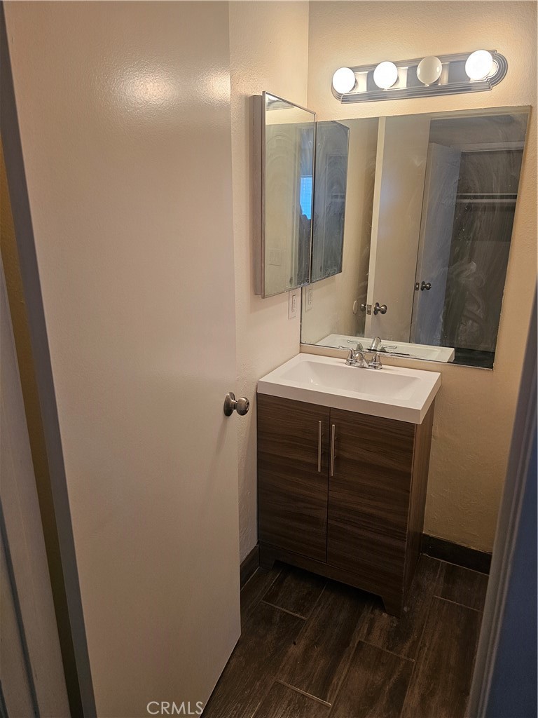 45419 10th Street West, Unit B Lancaster, CA 93534 - Photo 6 of 18 a bathroom with a sink vanity and a mirror