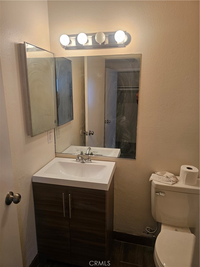 45419 10th Street West, Unit B Lancaster, CA 93534 - Photo 7 of 18 a bathroom with a toilet sink and mirror