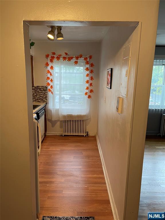 245 Passaic Avenue, Unit B4 Passaic, NJ 07055 - Photo 6 of 13 a view of a hallway with wooden floor and stairs