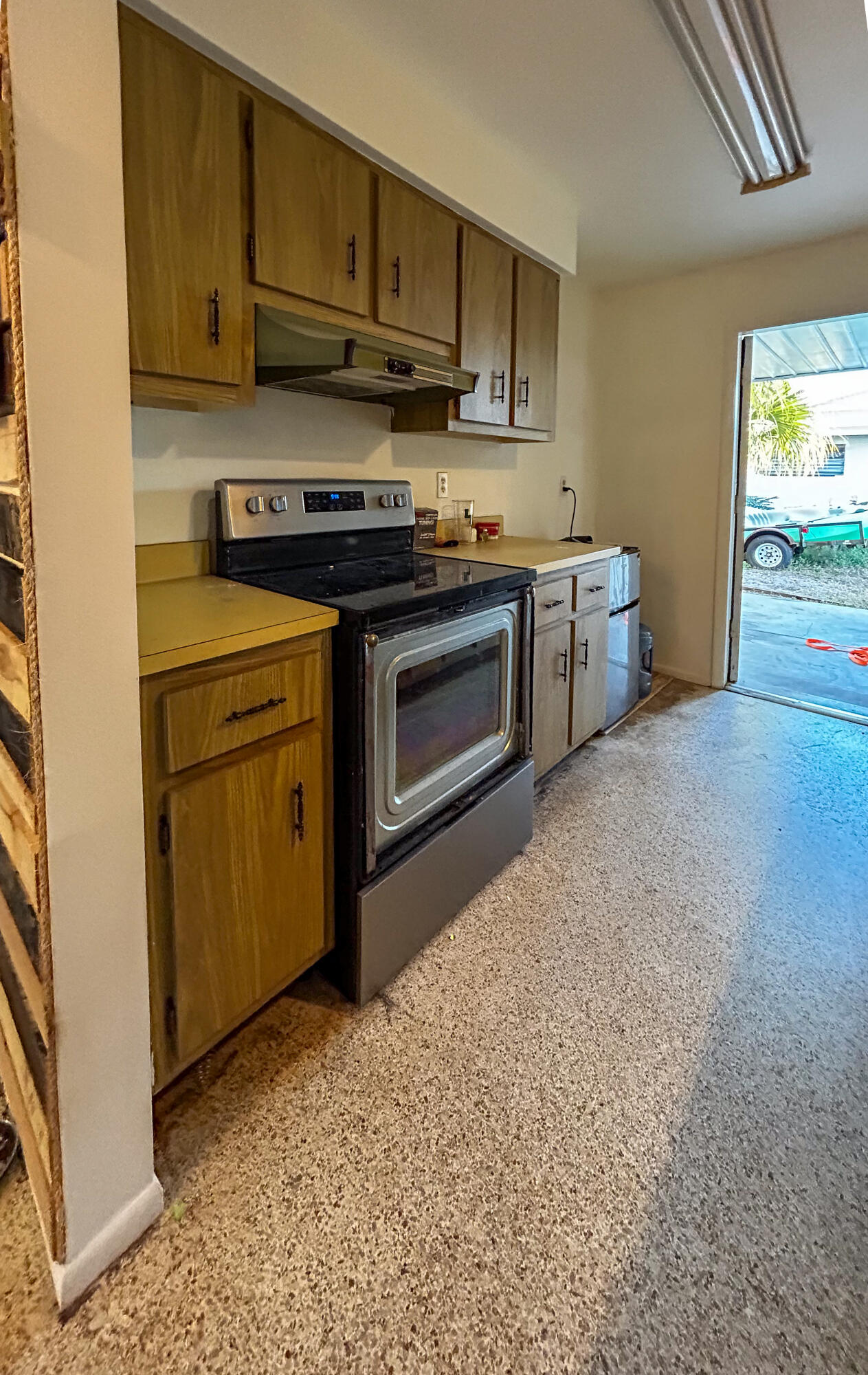868 Lance Street Sebastian, FL 32958 - Photo 11 of 37 a kitchen with stainless steel appliances granite countertop a stove a sink and a refrigerator with wooden cabinets