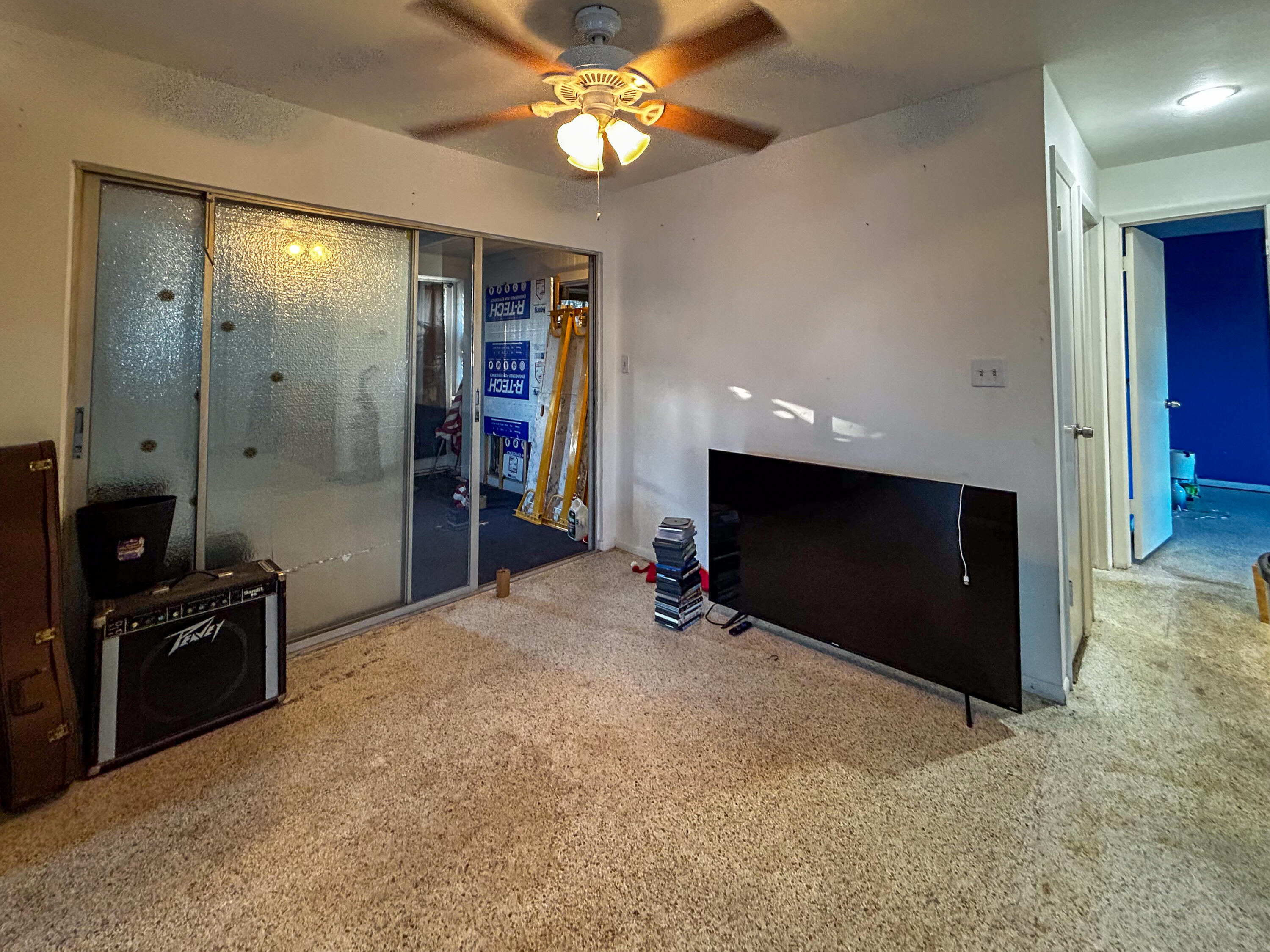 868 Lance Street Sebastian, FL 32958 - Photo 12 of 37 a view of an empty room with a fireplace and a fan