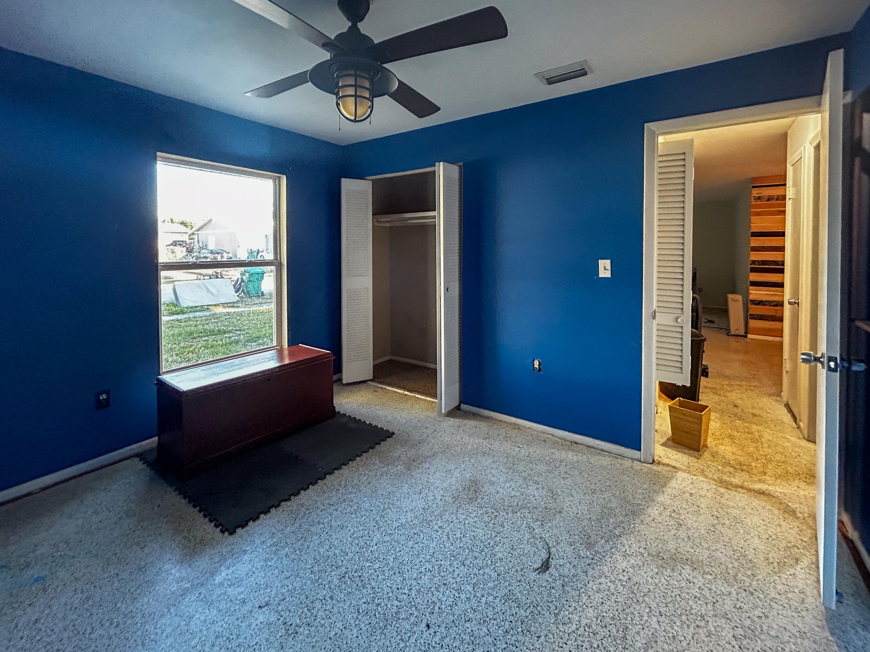 868 Lance Street Sebastian, FL 32958 - Photo 14 of 37 an empty room with windows and ceiling fan
