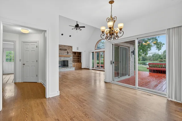 a view of a livingroom with wooden floor and a ceiling fan