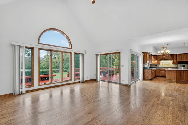 a view of a living room with hardwood floor and a large window