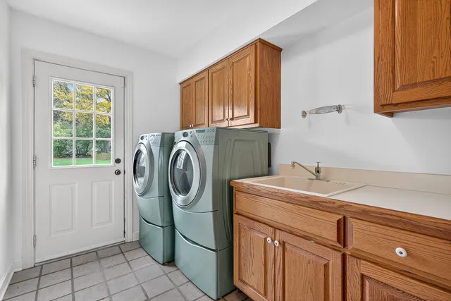 a utility room with sink dryer and washer