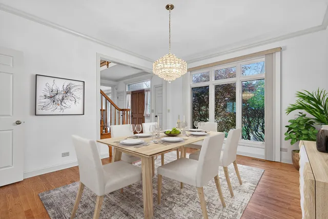 a dining room with furniture a rug and wooden floor