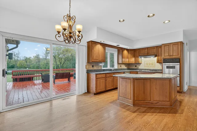 a kitchen with stainless steel appliances granite countertop a stove top oven a sink dishwasher a microwave oven with granite countertops and cabinets