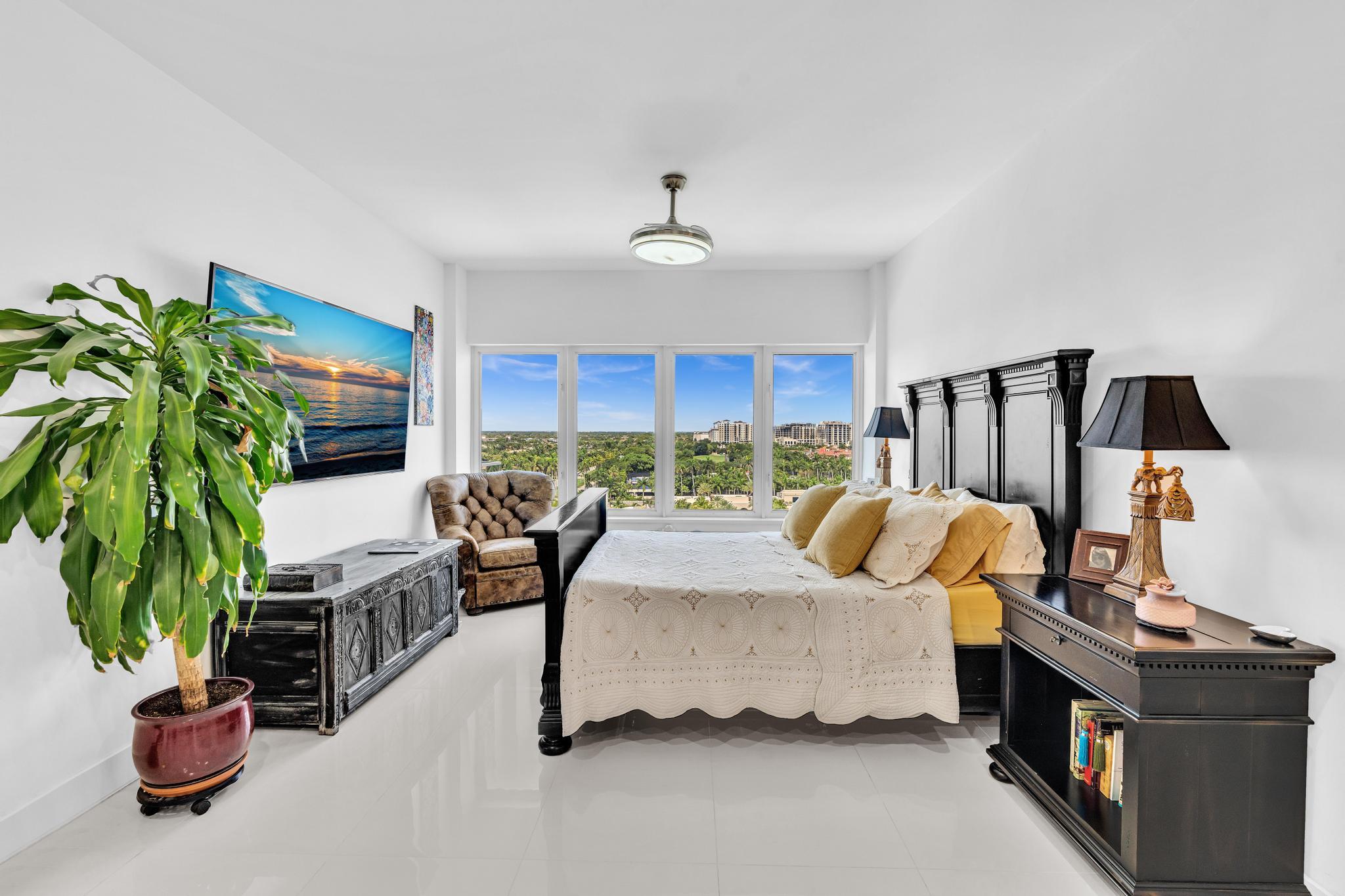 701 East Camino Real, Unit 12G Boca Raton, FL 33432 - Photo 30 of 82 a bedroom with furniture and a potted plant