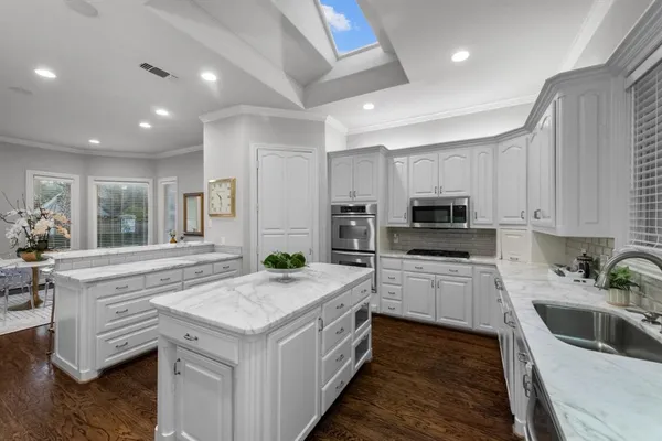 a kitchen with a sink stove and cabinets