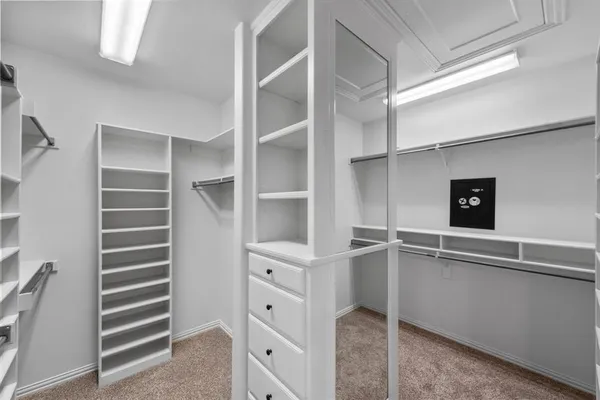 a large bathroom with a tub double vanity sink and a mirror