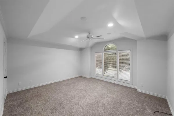 an empty room with a ceiling fan and a ceiling fan