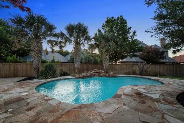 a view of a swimming pool with a patio