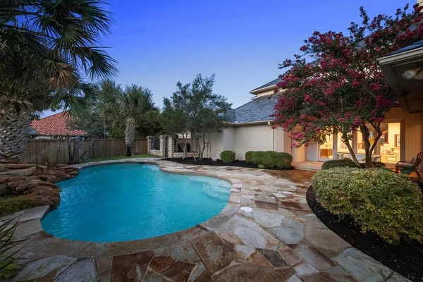 a view of a house with swimming pool and a yard