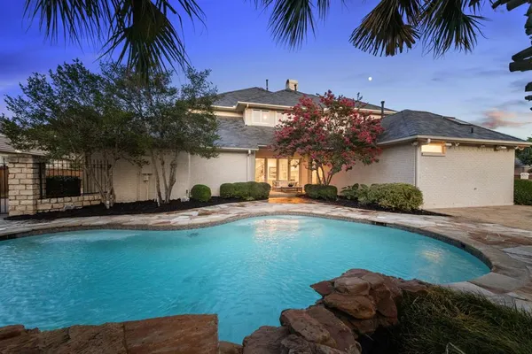 a view of a swimming pool with sitting area
