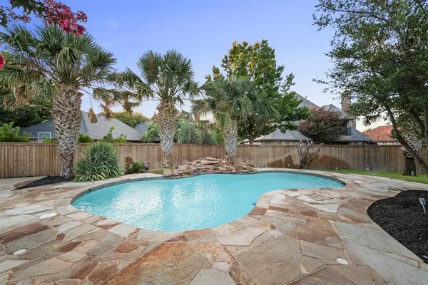a view of backyard with seating space and trees