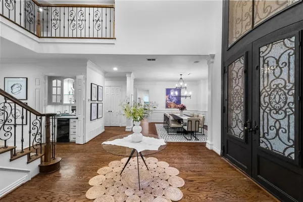 a living room with furniture large window and wooden floor