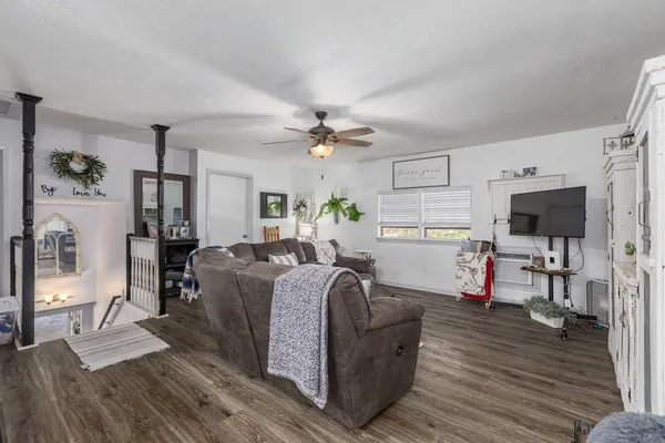 a living room with furniture and kitchen view
