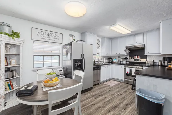 a kitchen with stainless steel appliances granite countertop a stove and a sink