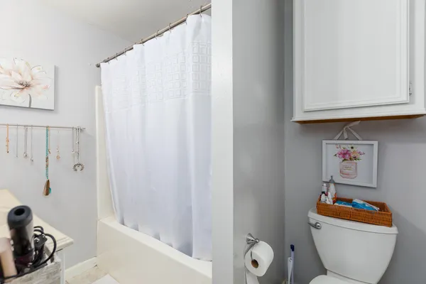 a bathroom with a sink toilet and a mirror