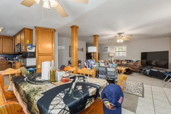 a living room with furniture a ceiling fan and a window