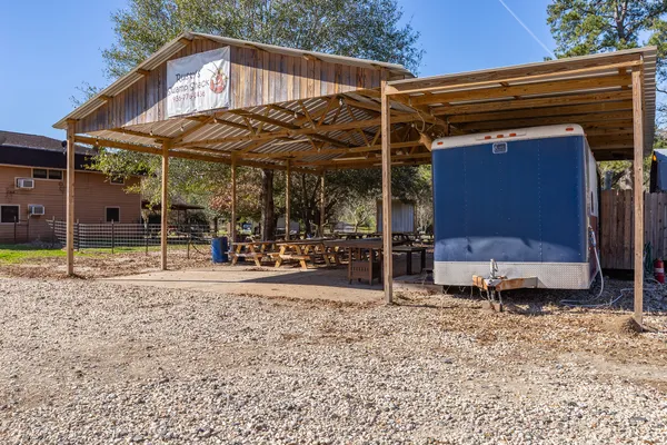 a view of a house with a yard and sitting area
