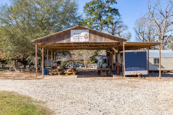 a view of a backyard with table and chairs with wooden floor