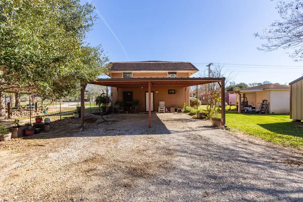 a house view with swimming pool in front of it