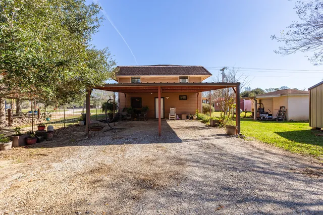 a house view with swimming pool in front of it