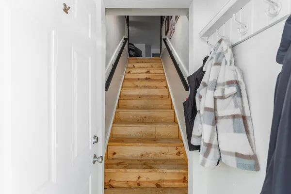 a living room with furniture a fireplace and a potted plant