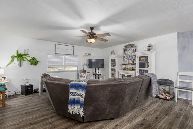 a living room with furniture a rug and a bookshelf