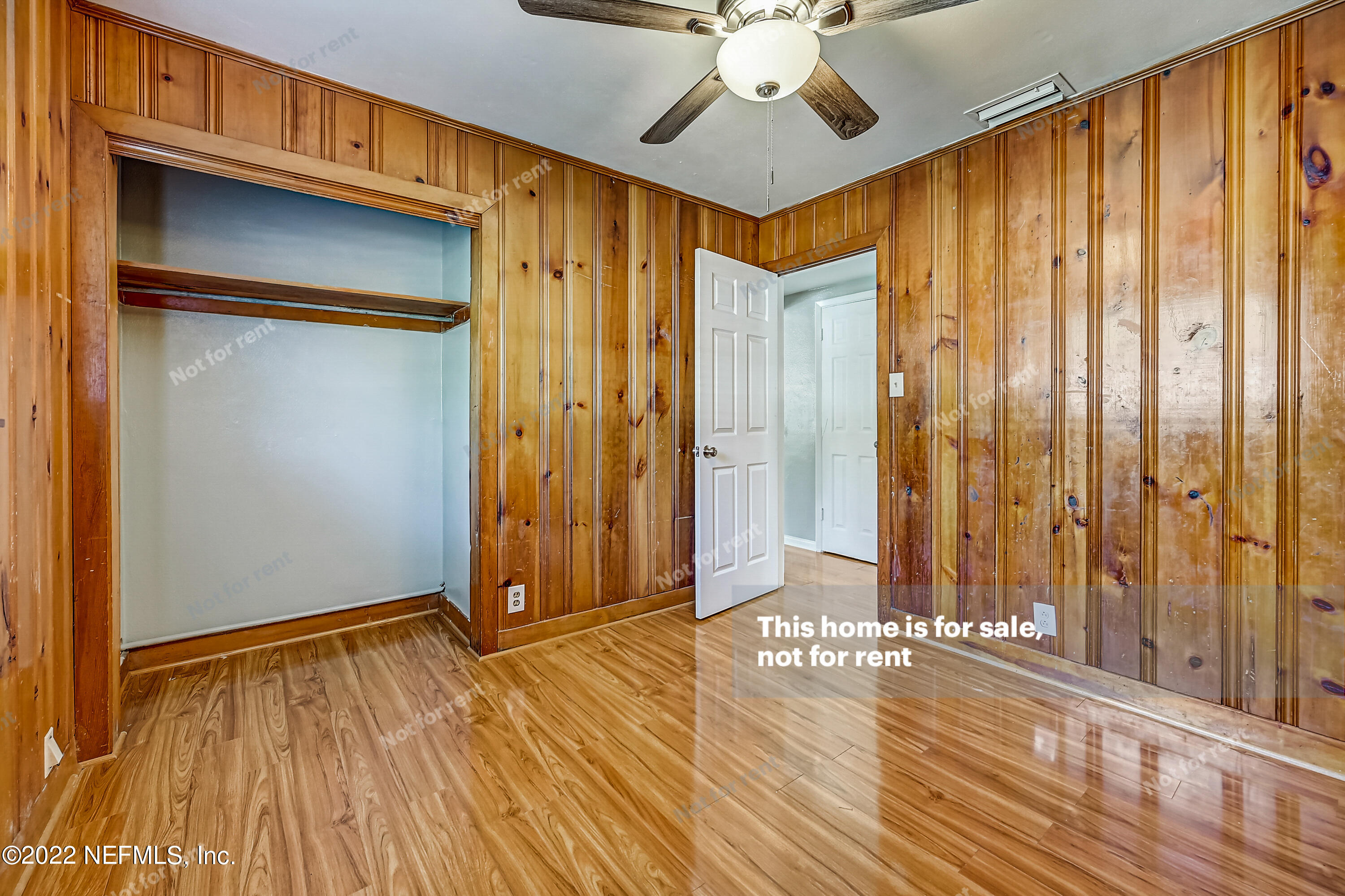 3383 Rogero Road Jacksonville, FL 32277 - Photo 23 of 29 a view of an empty room with wooden floor and a window