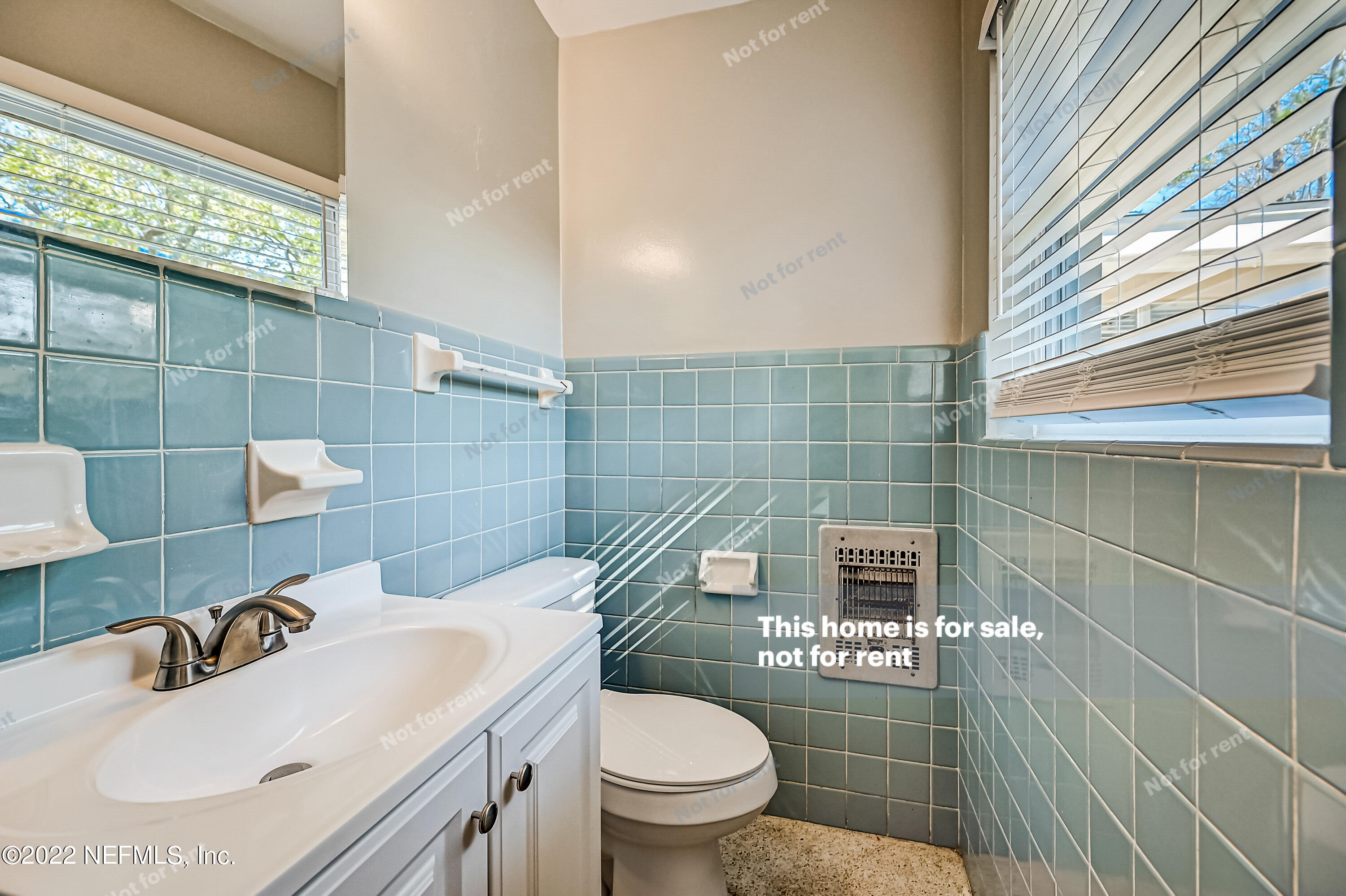 3383 Rogero Road Jacksonville, FL 32277 - Photo 8 of 29 a bathroom with a sink a toilet and shower