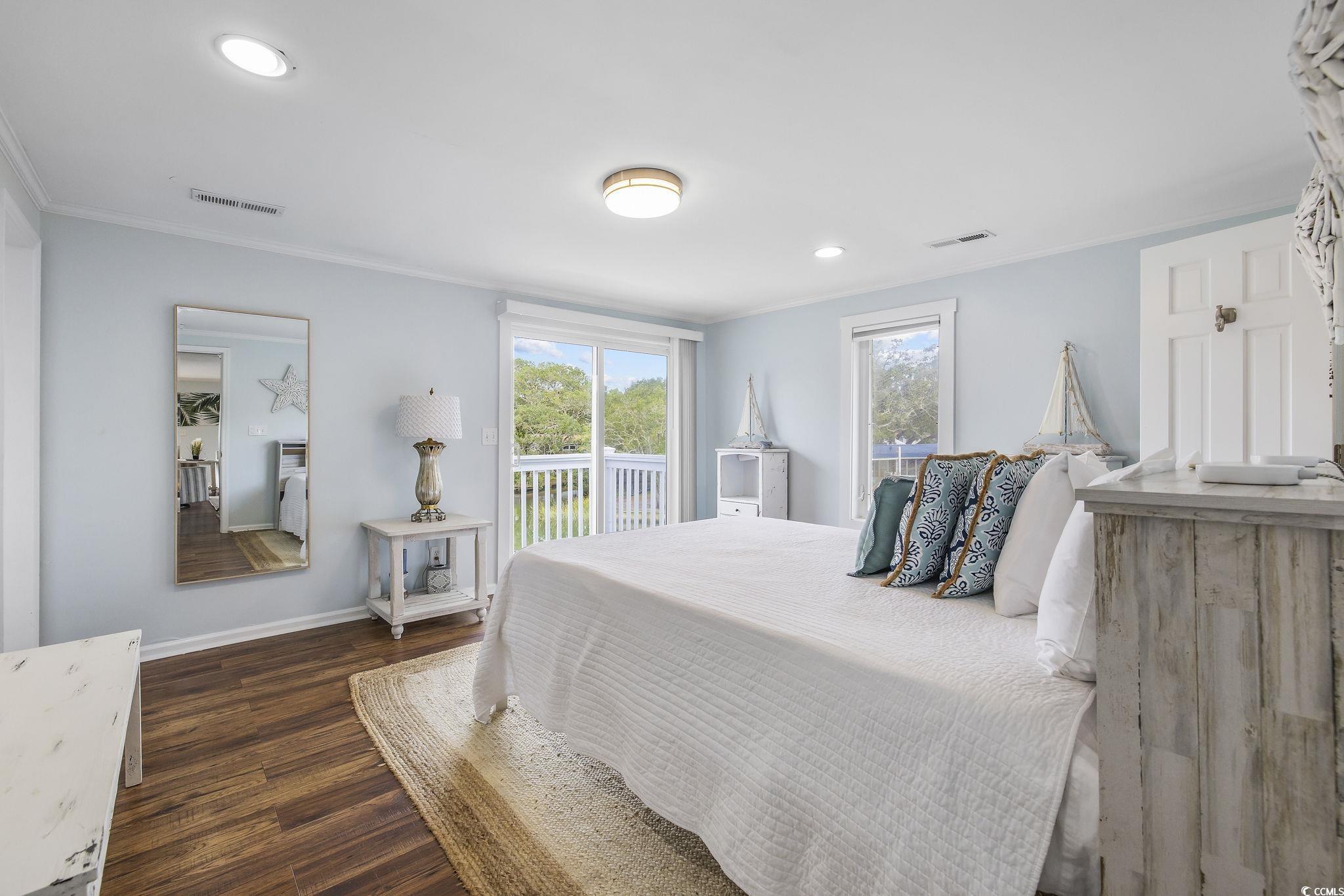 3184 State Rd S-26-816 Murrells Inlet, SC 29576 - Photo 25 of 40 Bedroom featuring access to outside, dark hardwood / wood-style floors, and ornamental molding