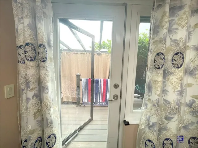 a view of a bathroom with shower and mirror