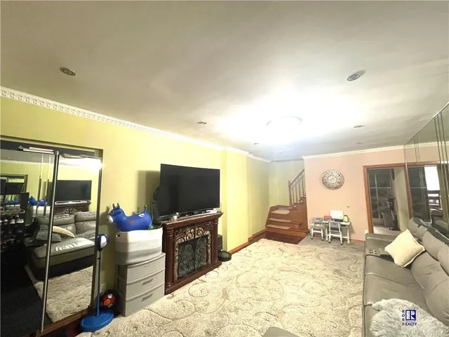 a bedroom with furniture and a flat screen tv