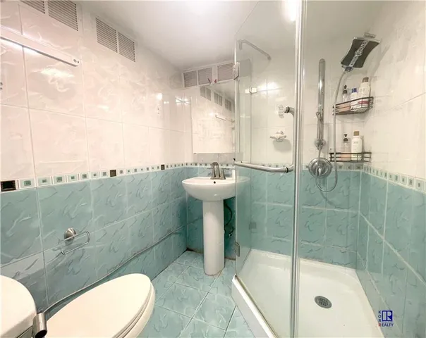 a bedroom with a bed and a large mirror