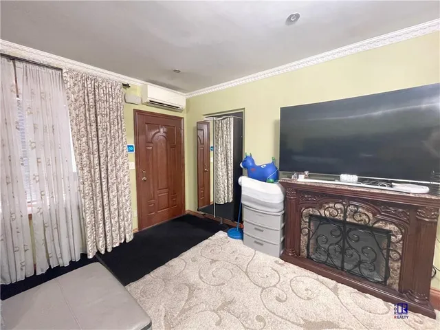a bedroom with a bed and a television